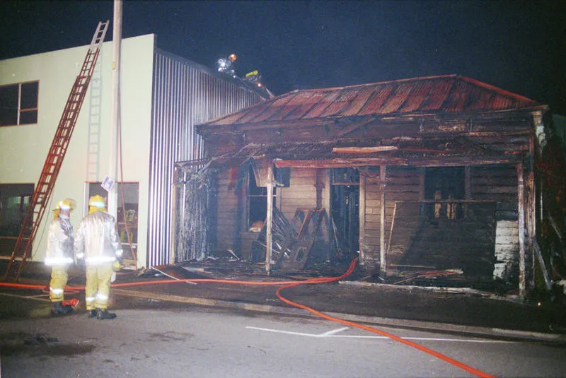 Firefighters dampen down the gutted remains of the Carlyle Street house