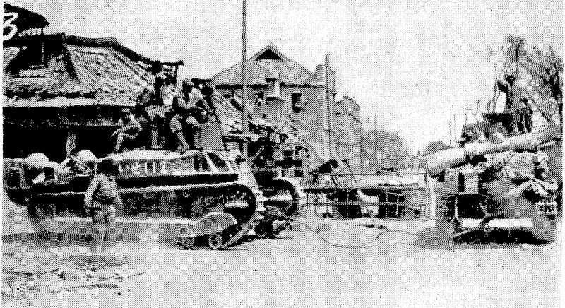 After the.bombardment of this Chinese town—somewhere in the war zone—Japanese troops are seen entering – with-tank and lorr^ (Evening Post, 27 July 1938)