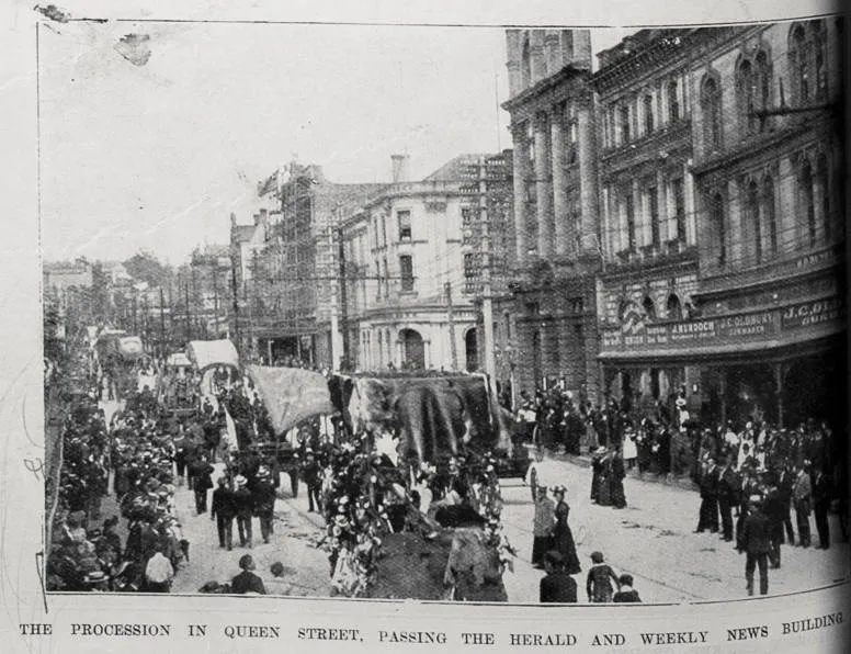 The procession in Queen Street, Auckland on Labour Day, 8 October 1902, passing the Herald and Weekly News building