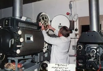 Ron Flaws loading a film reel : digital image