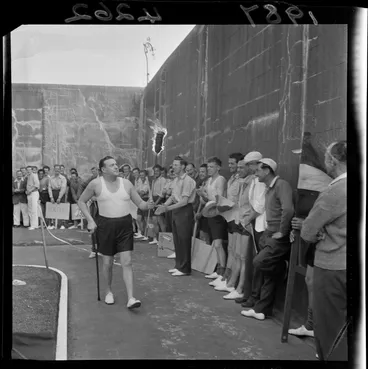 Image: An unidentified man carrying a burning torch past a group of prisoners, at a sports day at Mount Crawford Prison, Miramar, Wellington