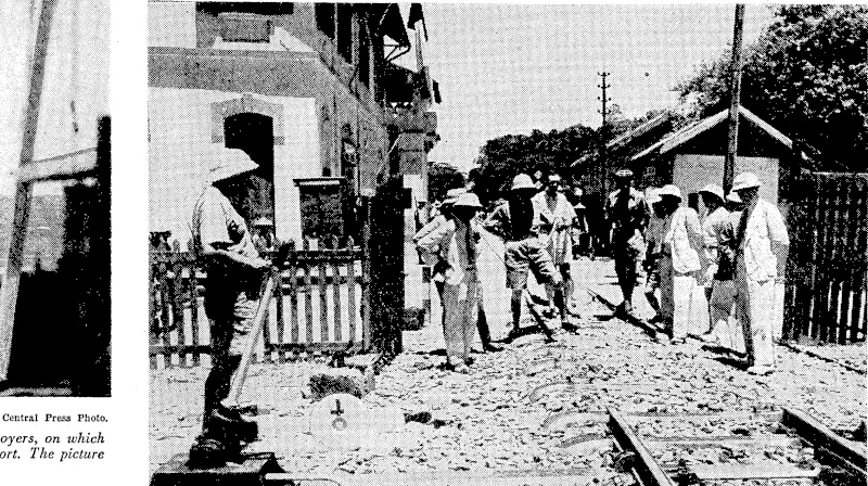 t- YafTa Photo. Traffic on the Haiphong-Yunnan railway was stopped recently when a short section of the rails was cut out on the Indo-China side of the border, near the Namshee Bridge. The picture shows Japanese and French officials examining the damaged line. (Evening Post, 27 September 1940)