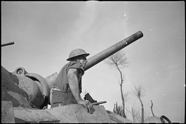 Image: New Zealander A F Hare emerges from drivers compartment of a Sherman tank on the Italian Front, World War II - Photograph taken by George Kaye