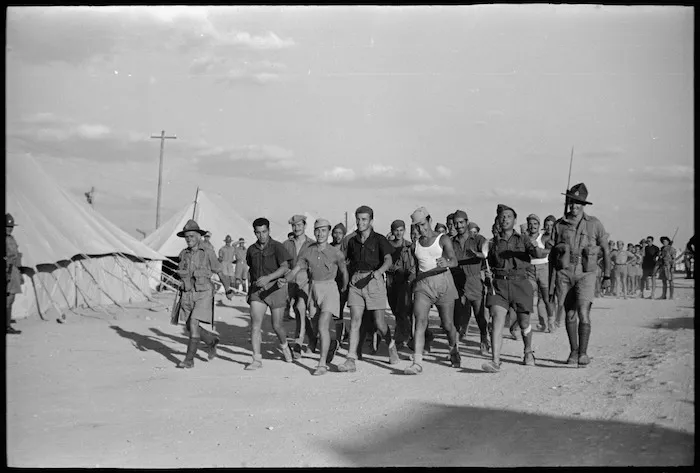 Italian prisoners marching back to POW cage after soccer match, Helwan
