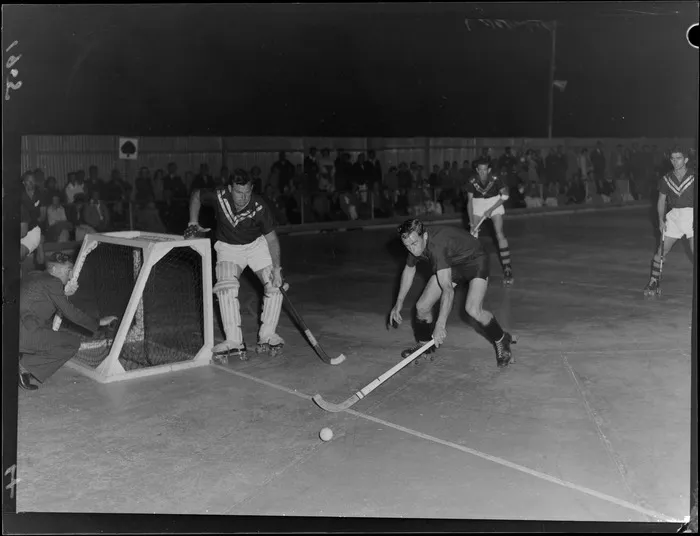 Unidentified team of men playing roller hockey on a rink in Lower Hutt