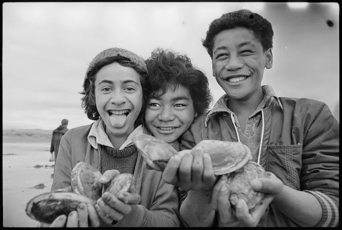 Three boys holding toheroa, Hokio Beach.