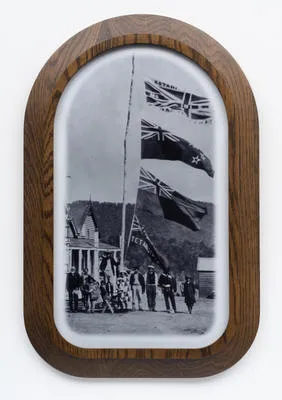 Kōtahitanga, Maungapōhatu (1908). Rua Kenana’s followers with 4 flags flying outside his residence. Top flag confiscated by police in 1916. It reads, “Two races, One People, Equal Rights”. Whakatāne Museum Photographic Archive–P10737. Photographer George Bourne, Auckland Weekly News