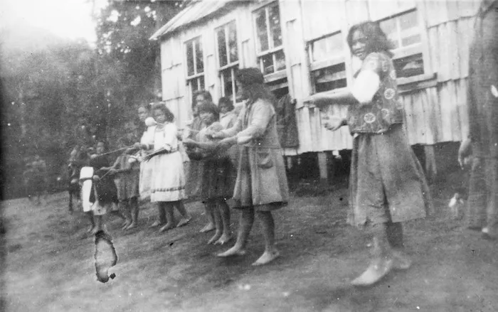 Children performing a poi dance outside the school at Ruatahuna