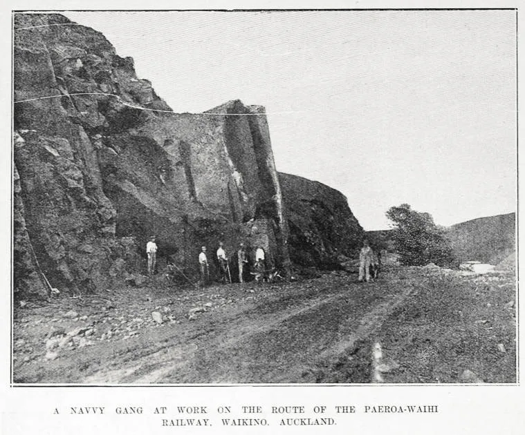 A NAVVY GANG AT WORK ON THE ROUTE OF THE PAEROA-WAIHI RAILWAY. WAIKINO. AUCKLAND