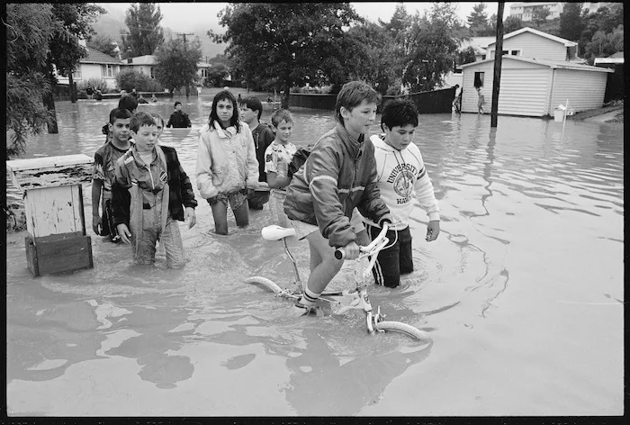 Children wading through floodwaters in Stokes Valley, Wellington - Photograph taken by Phil Reid