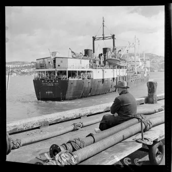 Japanese whaling ship Tenyo Maru No.3 out of Tokyo leaving a Wellington Harbour wharf with the crew looking back, Wellington City