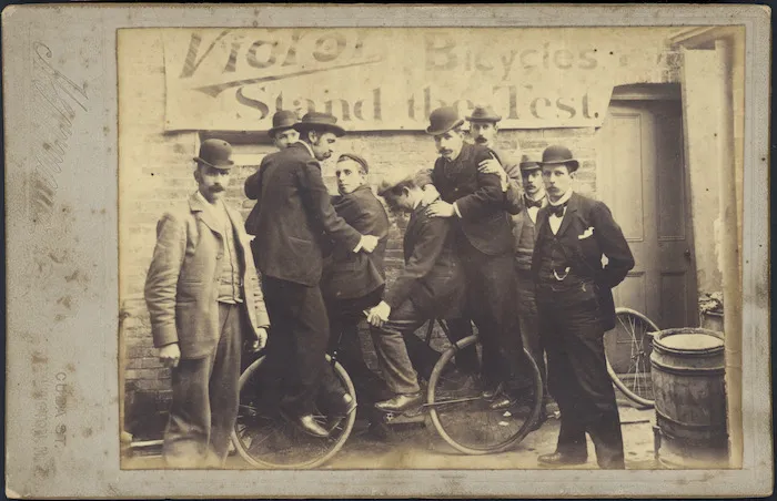 Four men on a "Victor" bicycle, Wellington.