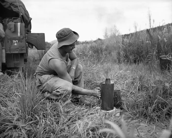 Gunner M A Traue of Gisborne boiling water on a Benghazi stove, Korea