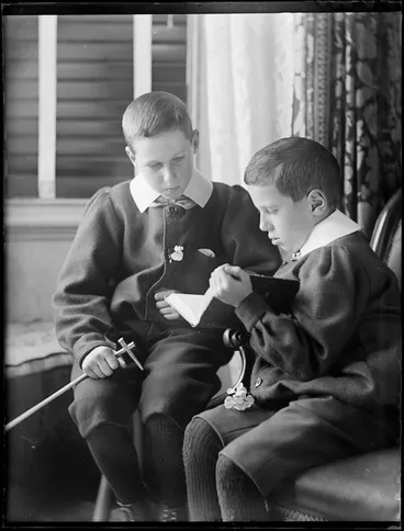 Image: Edgar and Owen Williams reading a book together within the living room of their home, Kew, Dunedin