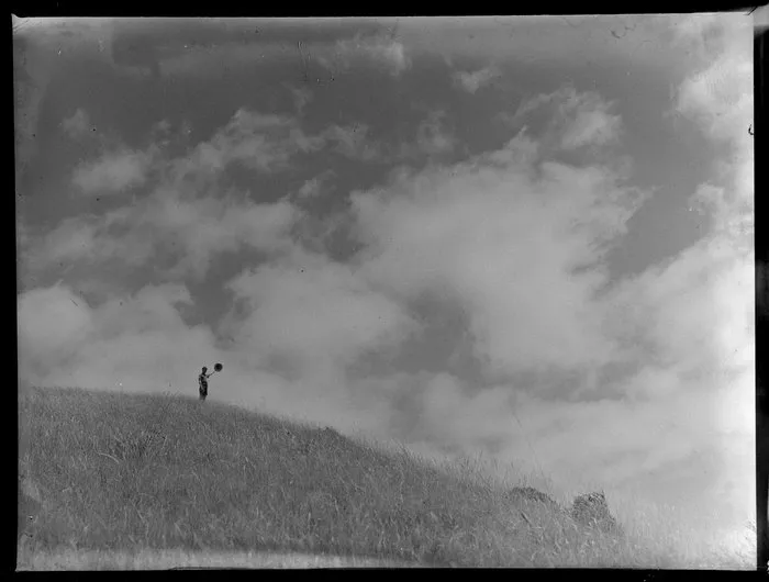 Summer Child Studies series, boy, waving his hat on an hilltop