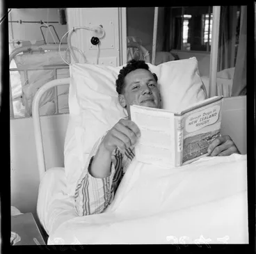 Image: D J Davison, a Junior All Black, in Wellington Hospital with the book 'Great Days in New Zealand Rugby'