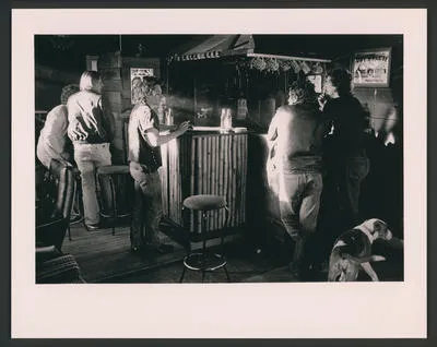 [Highway 61 members and associates socialise around the Headquarter's bar]