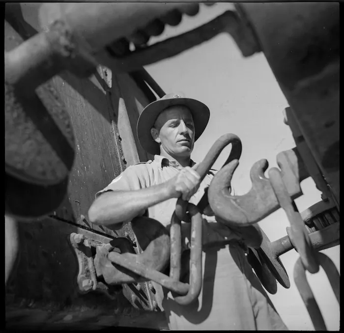 Sgt J Cheadle of the New Zealand Railway Operating Unit coupling up in the rail yard, Western Desert