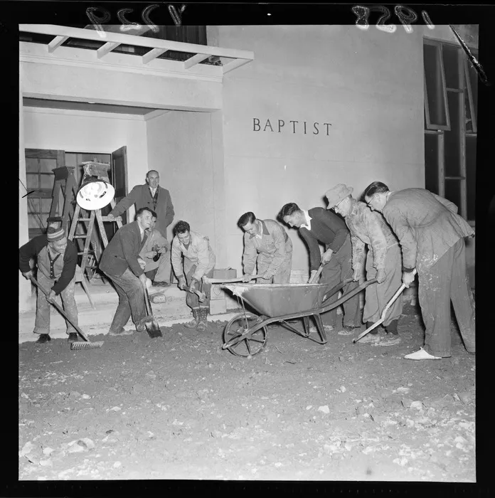 Group of unidentified men preparing the floor for opening of a Baptist Church at Wainuiomata, Lower Hutt City, Wellington Region