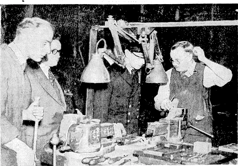 Sport and General" Photo. Members of the Royal Family have been visiting many of the factories and other places ivhere munitions are made and stored and where money is being raised for patriotic funds. Above, a nightshift craftsman in a shell-producing factory is attempting to answer a technical question by the King. Mr. Herbert Morrison, Minister of Supply, is standing next the King. Top right, Queen. Mary looking over the gifts to the "Spare a Trinket" Fund. General Nobuyuki Abe (with back to camera in the main picture and inset), Ambassador Extraordinary and Plenipotentiary to the new Central Government of China, addressing a huge gathering of students and others in Hibiya Park, Tokio, just before his departure from Japan. (Evening Post, 28 August 1940)