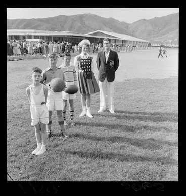 Image: Naenae gymnasium and sports field opening with unidentified boys, a girl and a man representing various sports, Hutt Valley, Wellington Region
