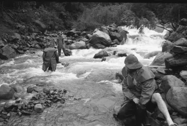 Image: Kaimai air disaster search and rescue volunteers cross a river, 1963