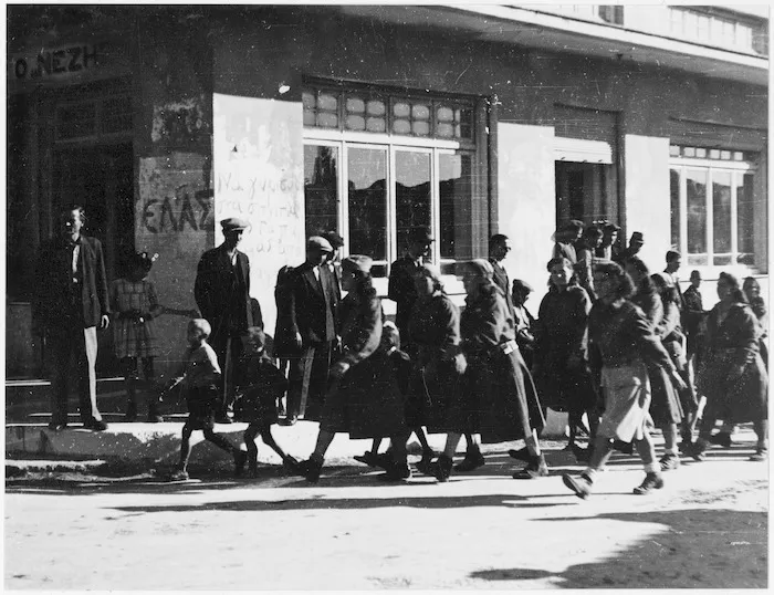 Greek female partisans marching from Parnassus through a village near Athens
