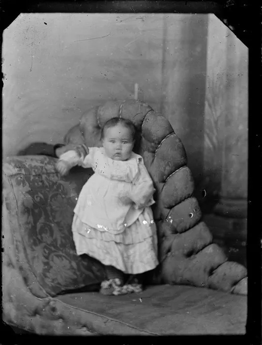 Unidentified baby standing on couch