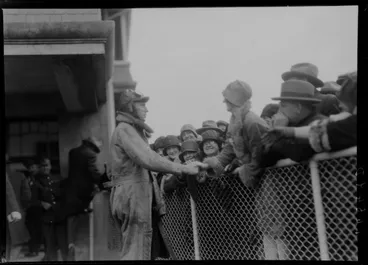 Image: Arrival of the Southern Cross at Wellington, possibly Trentham. Radio operator T H McWilliam greeting crowd
