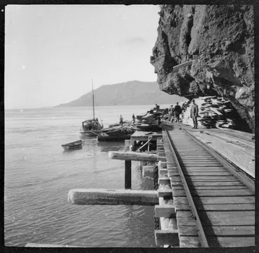 Image: Timber being loaded off the wharf at Whatipu, Piha tramway in foreground.