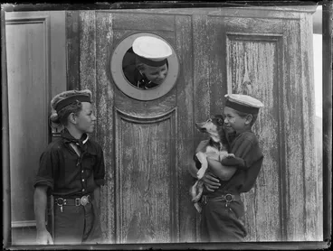 Image: Three unidentified sea cadets with a dog [puppy] on board four-masted barque Rewa, location unknown