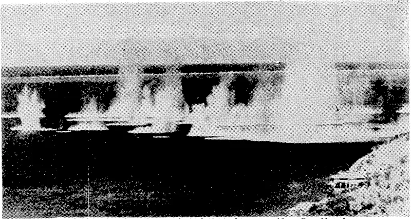 Bombs bursting along the waterfront during a Japanese raid on Port Moresby. (Evening Post, 18 August 1942)