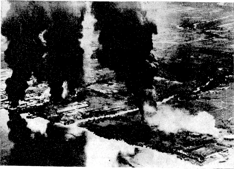 Carrier-based planes of the United States Pacific Fleet struck heavily at Japanese shipping and shore installations as they battered the coast and sea lanes off French lndo-China on January 11 Oil tanks are seen burning furiously following the raid on Japanese fuel dumps at Saigon, ivhere oil tanks, refineries, and storage facilities were, destroyed or severely damaged. (Evening Post, 20 February 1945)