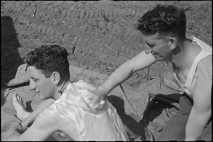 G E Burke and K O J Smith, NZ Infantry, clean up while resting behind the line on the Cassino Front, Italy, World War II - Photograph taken by George Kaye