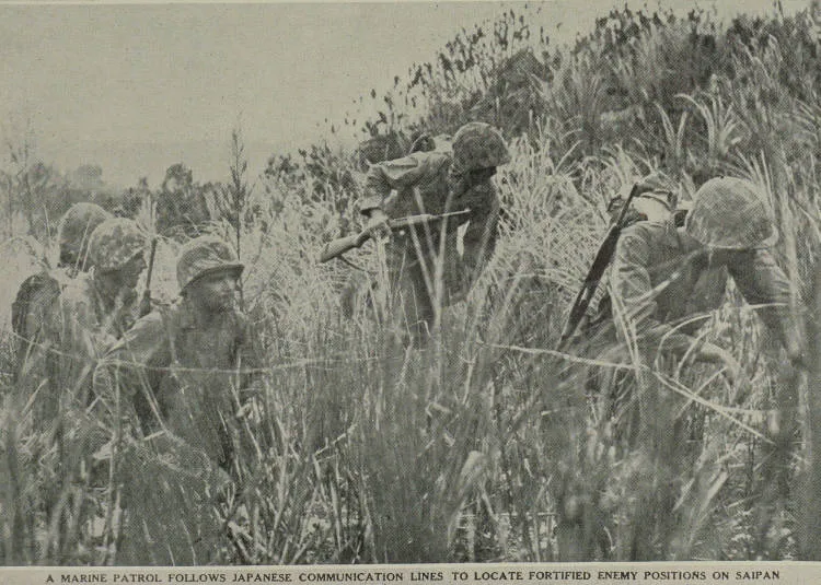A Marine patrol follows Japanese communication lines to locate fortified enemy positions on Saipan