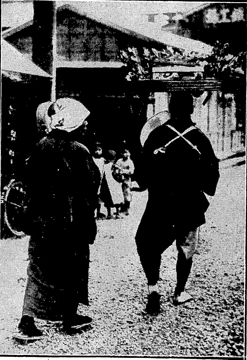 Sport and General",PHoto, SWEET SELLER IN THE STREETS OF TOKlO.—Children all the world over delight in gaily-coloured sweets, and Japanese children arc enthusiastic ivhen they see the sweet vendor with his drums and paper windmills advertising his wares. (Evening Post, 16 November 1932)