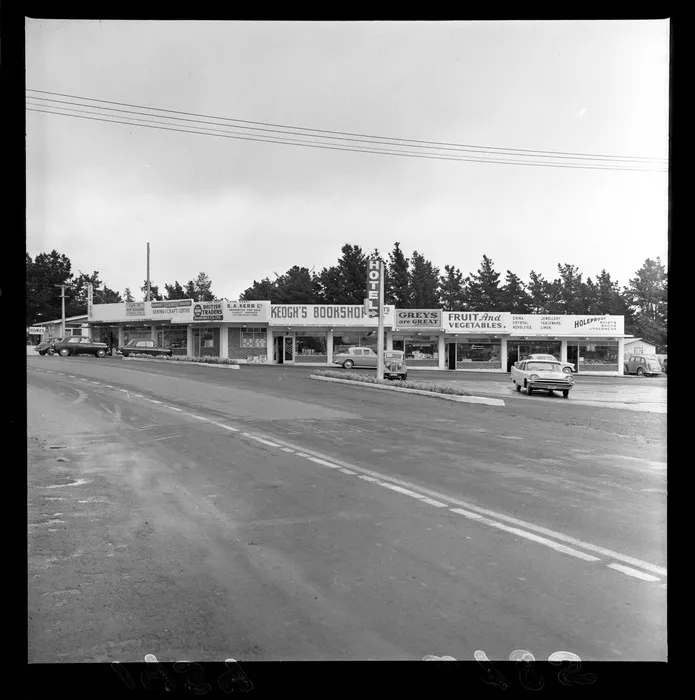 Shopping area, Main Road, Paraparaumu, Kapiti Coast district, showing business premises including SA Kerr Ltd, Norman's Drapery, Keogh's Bookshop, and Param Gift Store