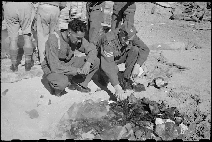 Members of the 28th (Maori) Battalion with uncovered hangi at Maadi Camp on Christmas Day, Egypt - Photograph taken by George Robert Bull