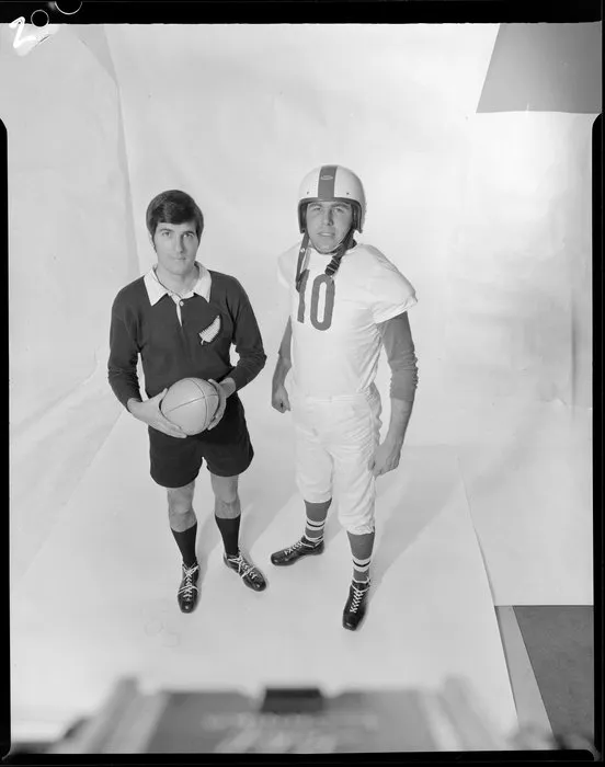 Two men in All Blacks and Gridiron uniforms