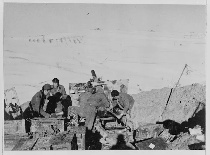 Gun crew firing 'Happy New Year Fritz' message from their Castel Frentano position in Italy