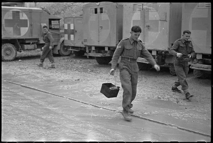 Members of a New Zealand Field Ambulance Unit in Italy receive their Christmas dinner, World War II - Photograph taken by George Kaye