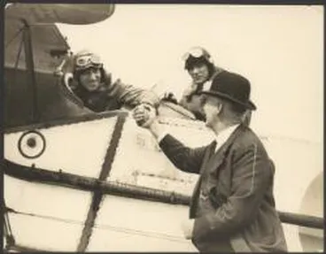 Image: Charles Kingsford Smith and Charles Ulm in cockpit of Bristol Tourer biplane, being met on arrival by Mayor George Baildon at Auckland, New Zealand, September 1928 / Auckland Sun