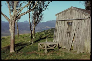 Image: Abandoned house and tank stand in view of Castle Rock.