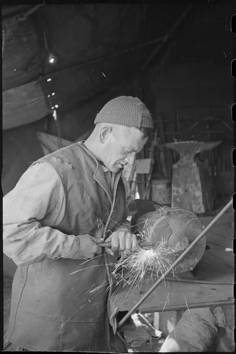 I Ross working with an emery wheel NZ Divisional Field Workshops, Italian Front, World War II - Photograph taken by George Kaye