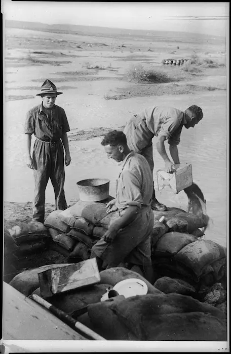 Bailing out flooded signals quarters in the desert, Egypt