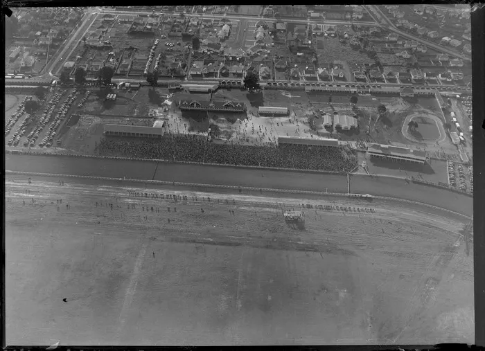 Avondale, Auckland, showing crowds at Avondale Racecourse, and bordering houses