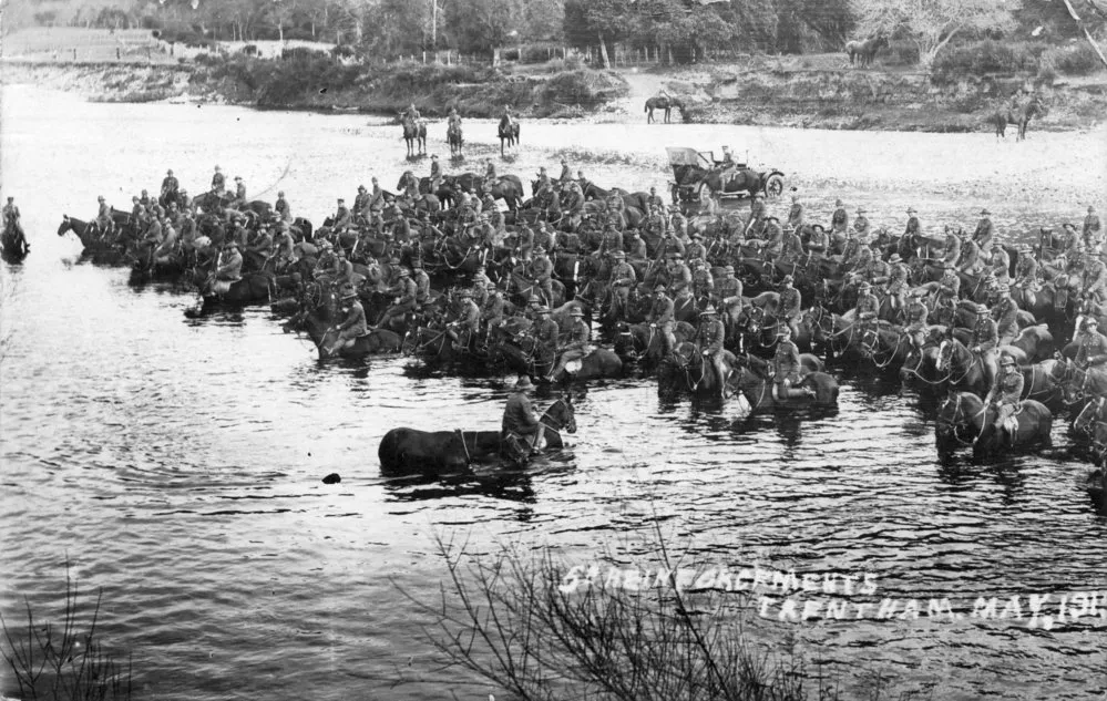Soldiers on horseback in Te Awa Kairangi / Hutt River, Trentham.