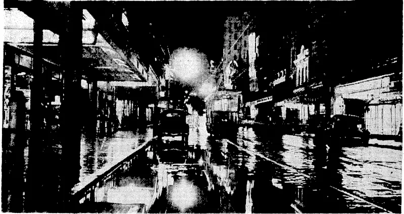 Sport' and General" PKoto. Boom of boats built by the Chinese across the Yanglze-kiang.River, and,set-on fire by tMe Japanese on January.%. ~.-Â„. ;■-,.. .- ■■-.'.'.■ ;■. .■ .■.Â•■'.':'. ; .' ; ..■ '' ,'. .. ' '■■' W. ■ Hail. Balne i'hoto. Willis Street, Wellington,:on?Saturday night,wwrenhren a burst "of'rain shortly after -9^ o'clock:flooded.the ■Â•''■,-" streets and'gave many people a good soaking. '. : . ■ ■ ' ■■ Â• (Evening Post, 07 February 1938)