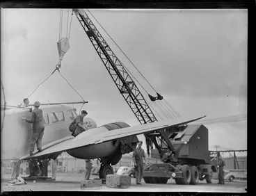 Image: Detaching crane tackle from Cessna aircraft, Kings wharf, Auckland