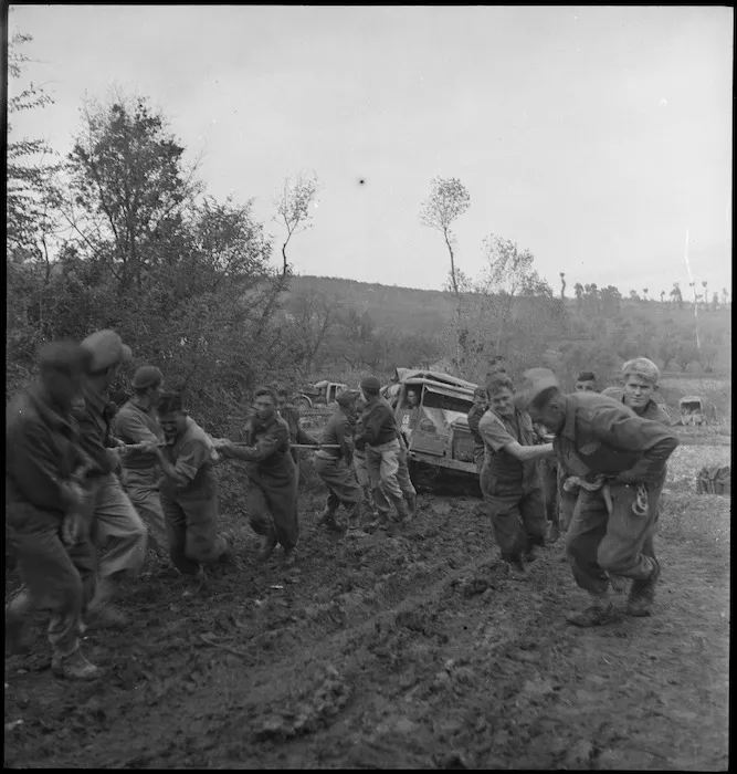 Manpower assisting a truck in the heavy going forward areas of the Sangro Front, Italy, World War II